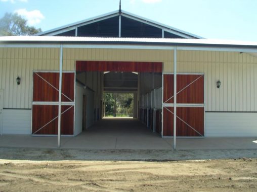 Double front wood doors at front of Breeze-Way Stable