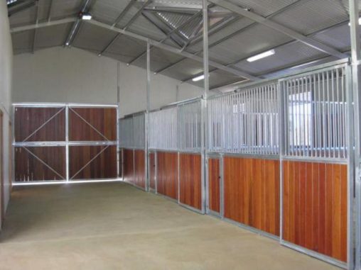 Front double wood doors /stalls lined with wood bars above